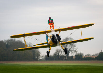 Save the Children Jumping Jumpers Wing Walker on a yellow bi-plane - TOMO Events